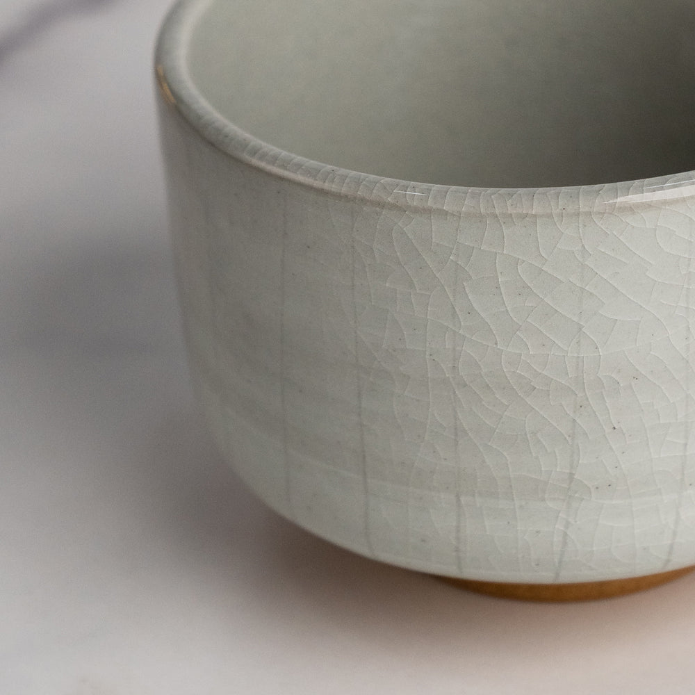 Close-up of a textured ceramic bowl on a light background