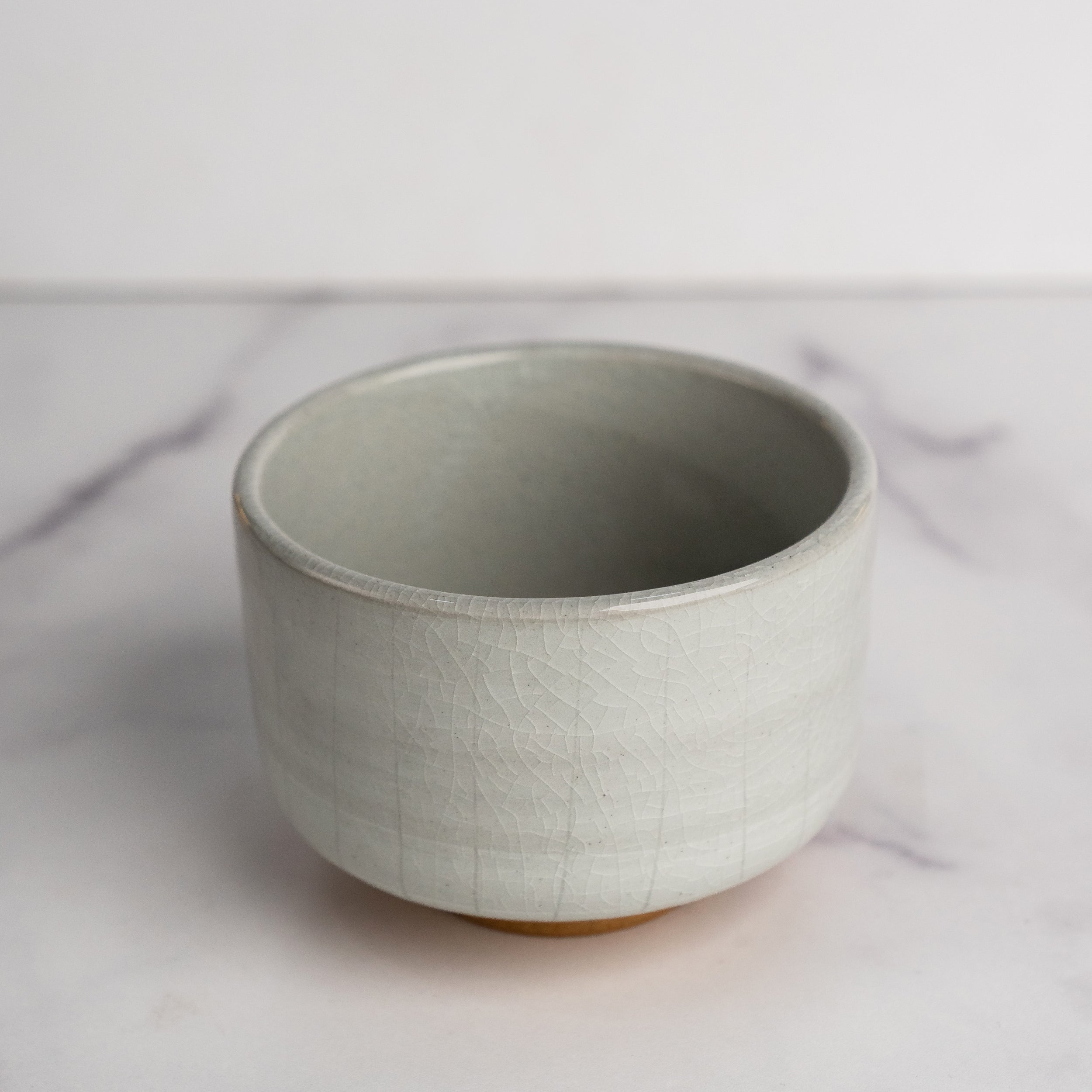 Ceramic bowl on a marble surface with a white background